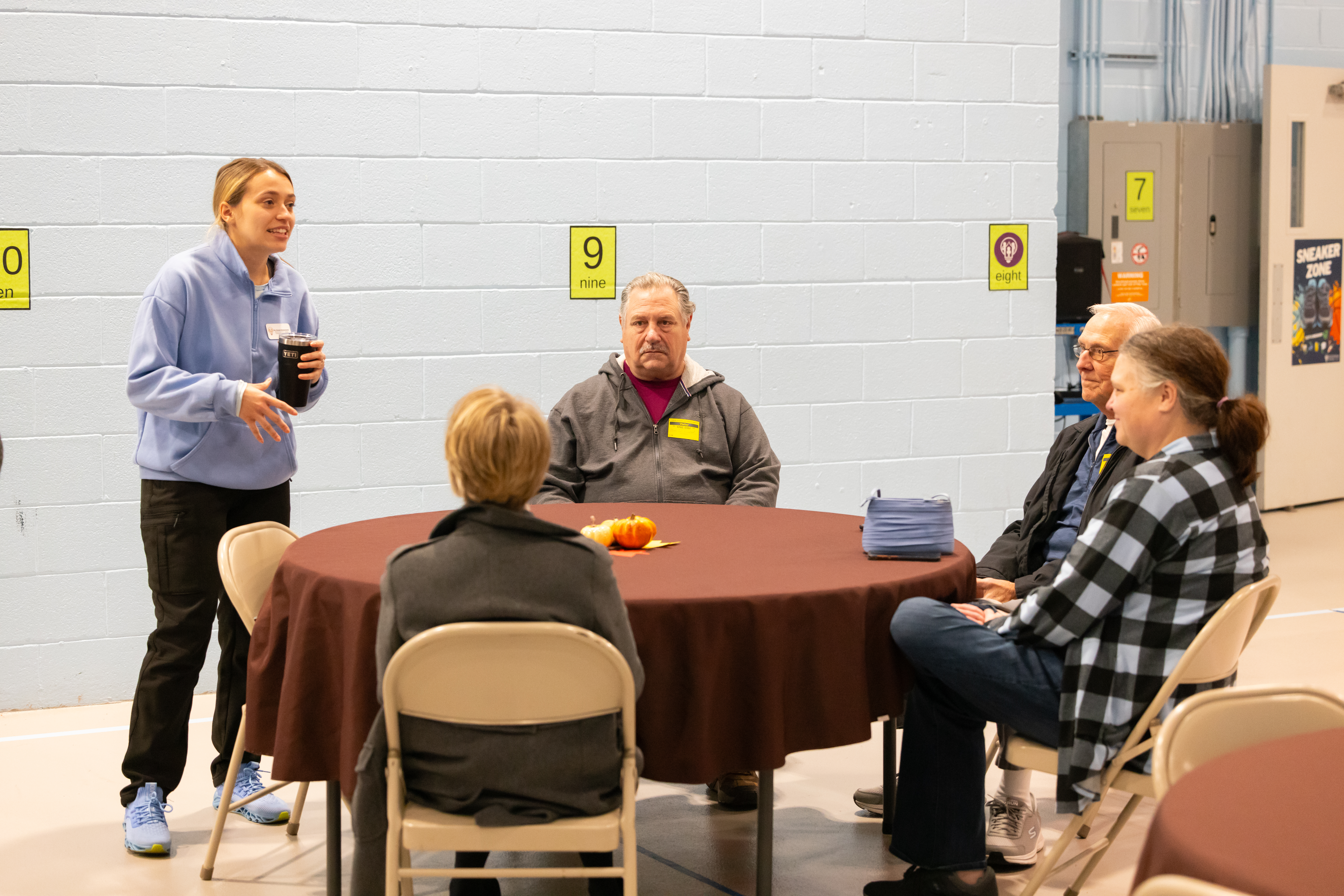 teacher talking to parents sitting at a table